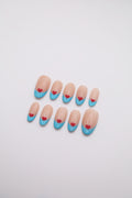 Airy Beat light blue French tip oval press-on nails set with red heart art flatlay
