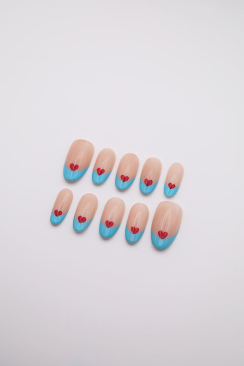 Airy Beat light blue French tip oval press-on nails set with red heart art flatlay