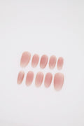 Blush Haze matte pink blush ombre oval press-on nails set display on dark background