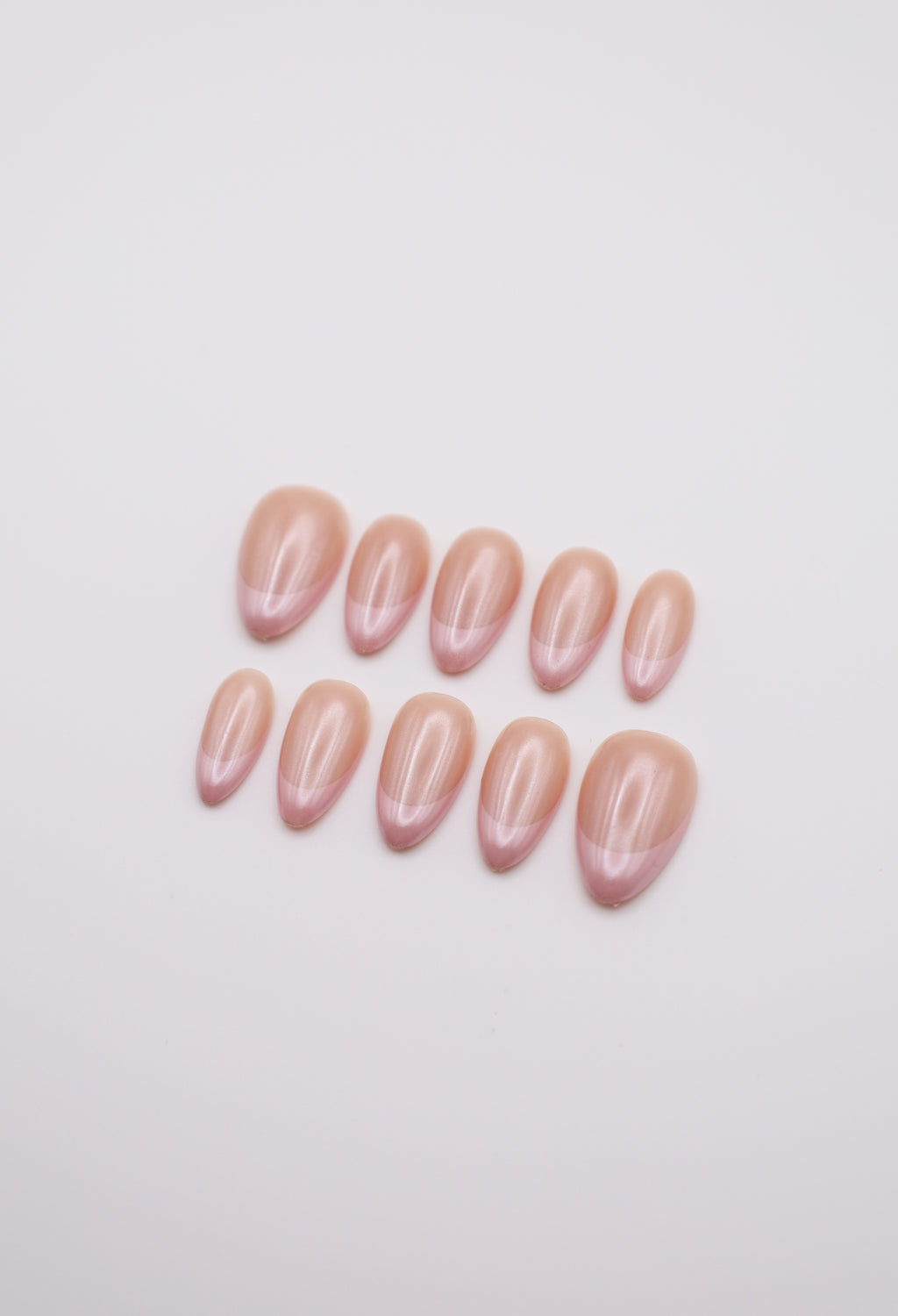 Sheer nude and hailey bieber glazed  pearl chrome French tip press-on nails set flatlay