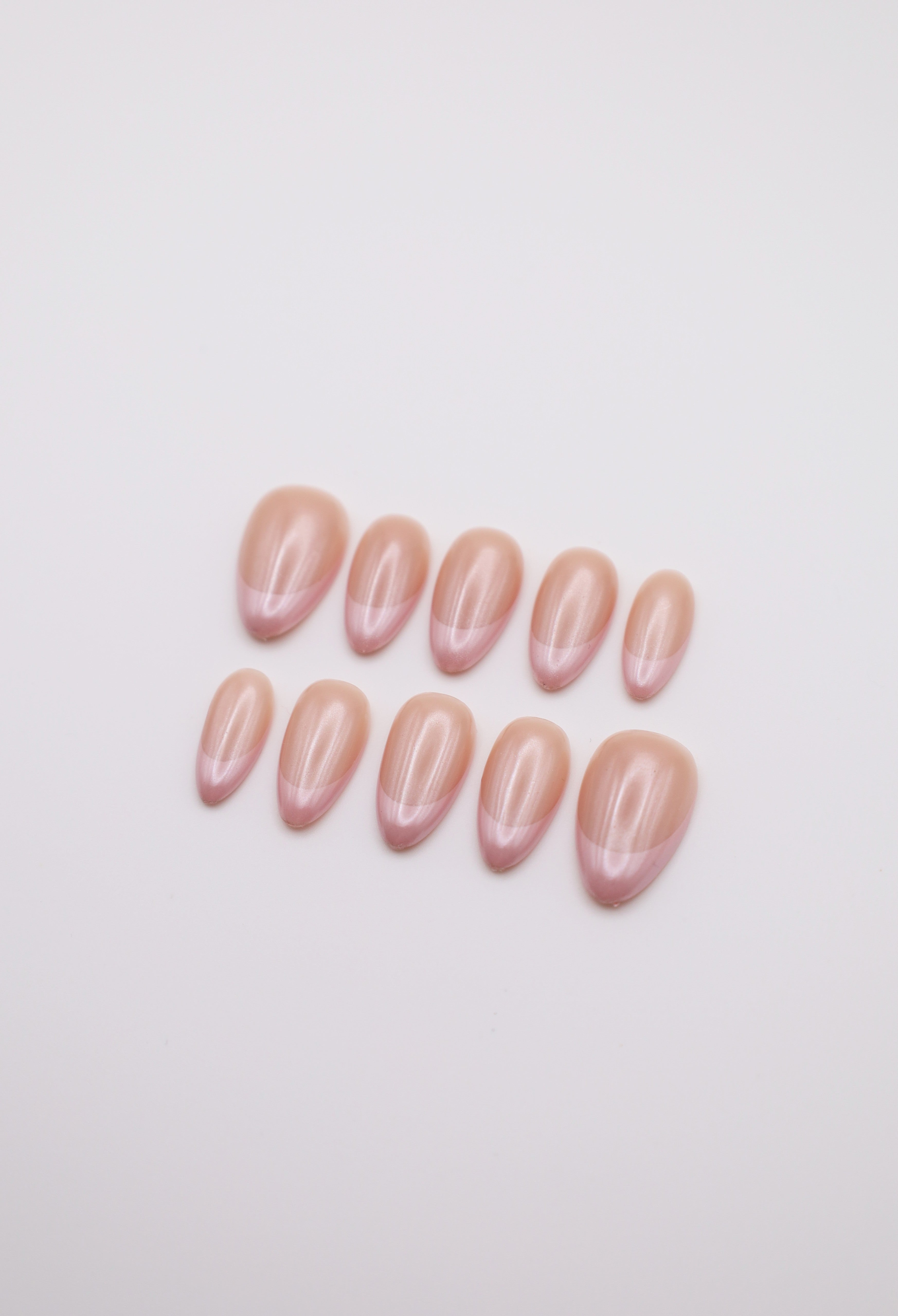 Sheer nude and hailey bieber glazed  pearl chrome French tip press-on nails set flatlay