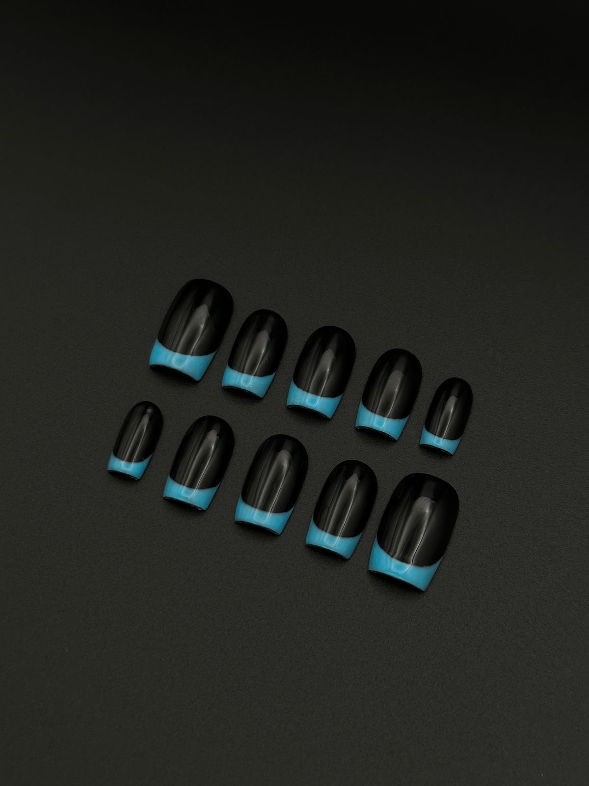 Midnight Blue glossy black and light blue reverse French square press-on nails set flatlay