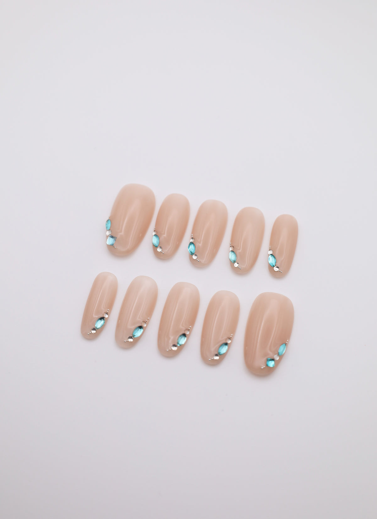 Mist Gem short oval nude press-on nails set with teardrop rhinestones flatlay display