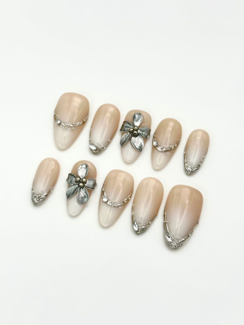 Pale Flora white gradient almond press-on nails set with 3D silver chrome accents display