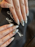 Pale Flora nude and white French ombre press-on nails with 3D silver chrome flower on hand