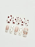 Pale Ribbon French tip and polka dot coffin press-on nails set flatlay display