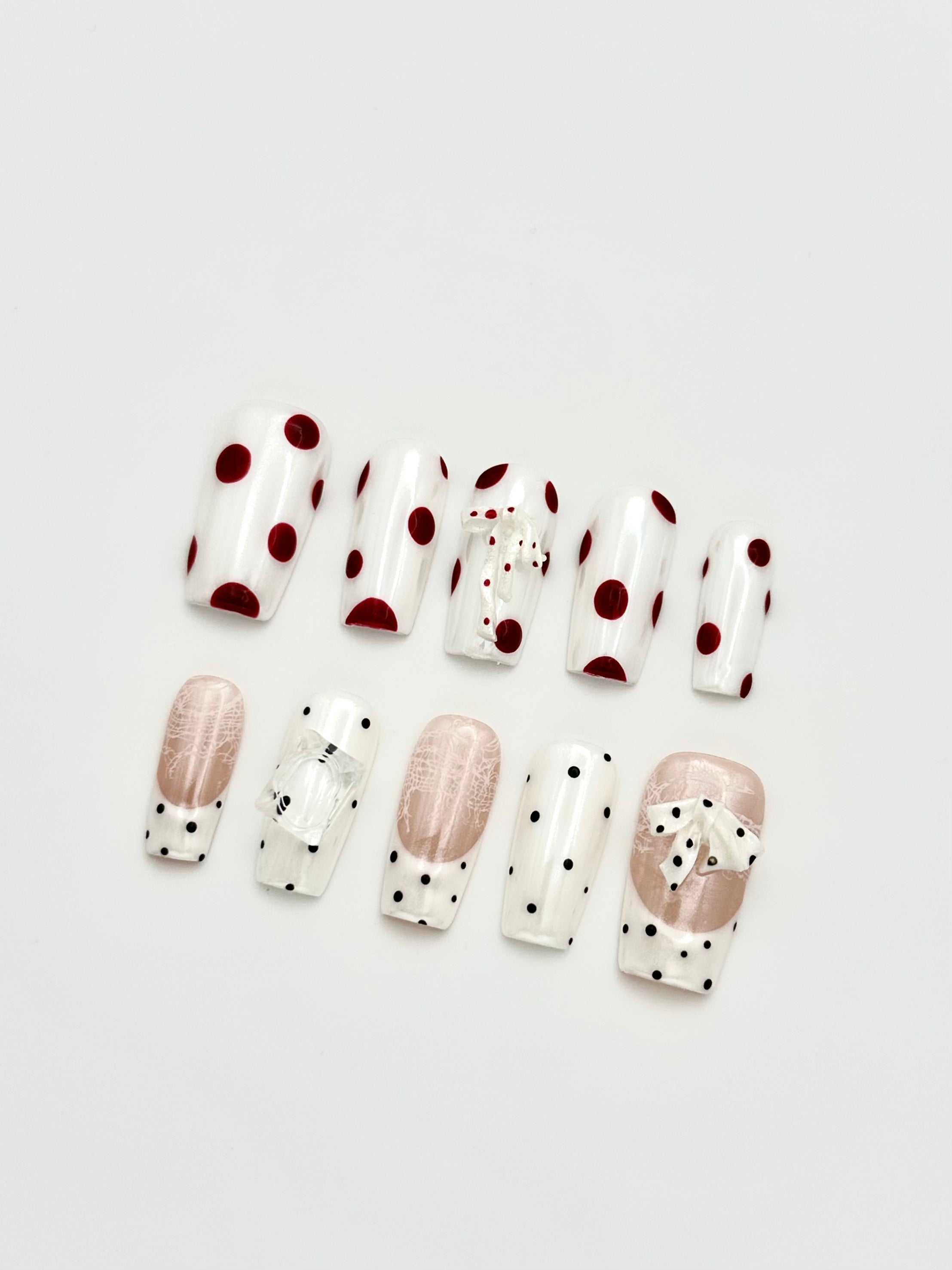 Pale Ribbon French tip and polka dot coffin press-on nails set flatlay display