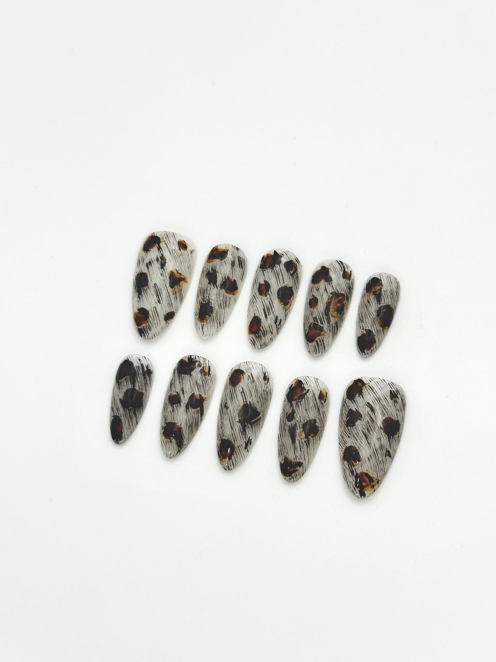 Sepia Dapple black and brown tortoiseshell almond press-on nails set flatlay display