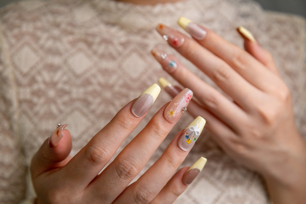 Spring Dust pale yellow French press-on nails with real dried flowers on hand