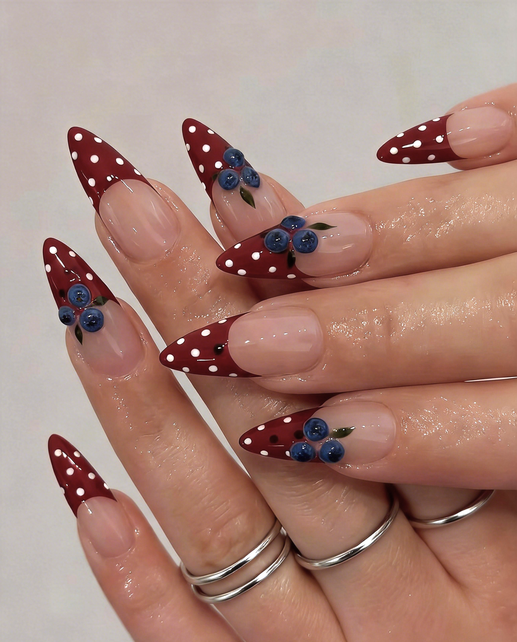 Wine Berry red polka dot French press-on nails with blueberry art on hand